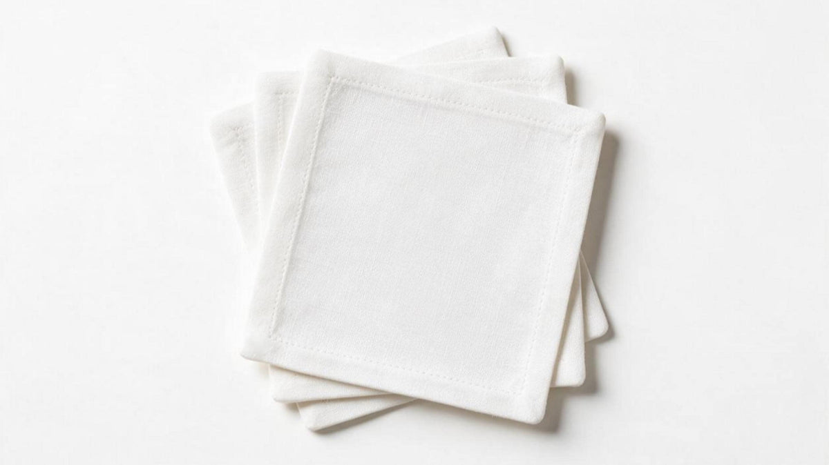 Four premium white European linen coasters displayed on a pure white background with authentic woven linen texture.
