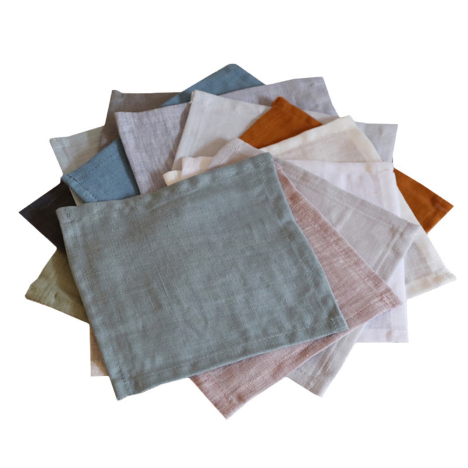 Washed linen coasters in multiple colors including sage green, blue grey, dark grey, natural, white, blush pink and mustard, fanned out on white background