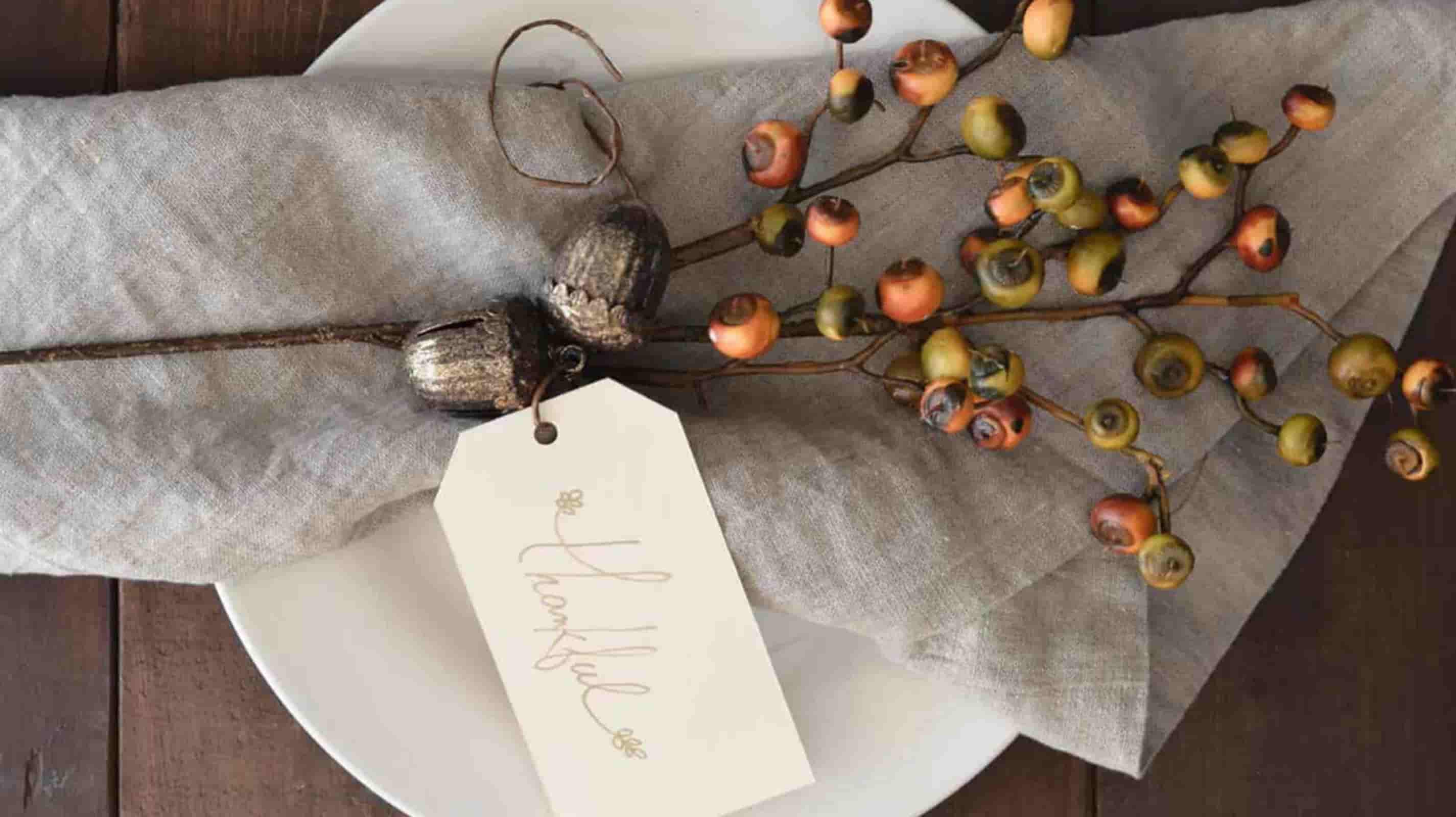 European linen napkins styled on a luxury restaurant table with ceramic dinnerware and crystal wine glasses.