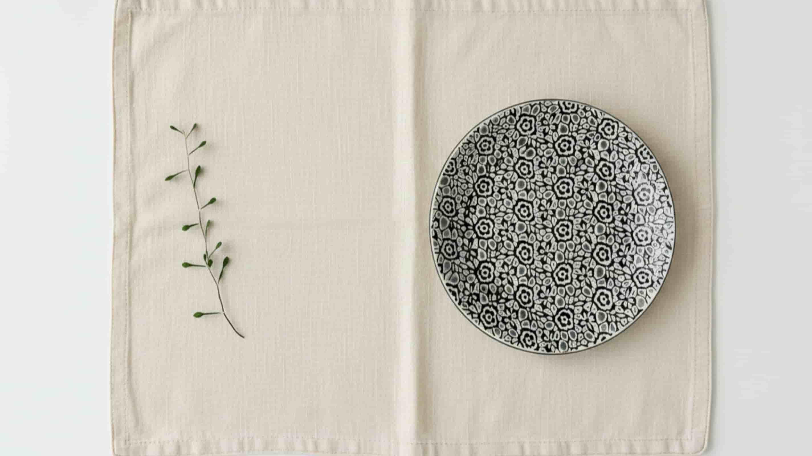 Natural linen placemat with ceramic plate overhead minimal shot