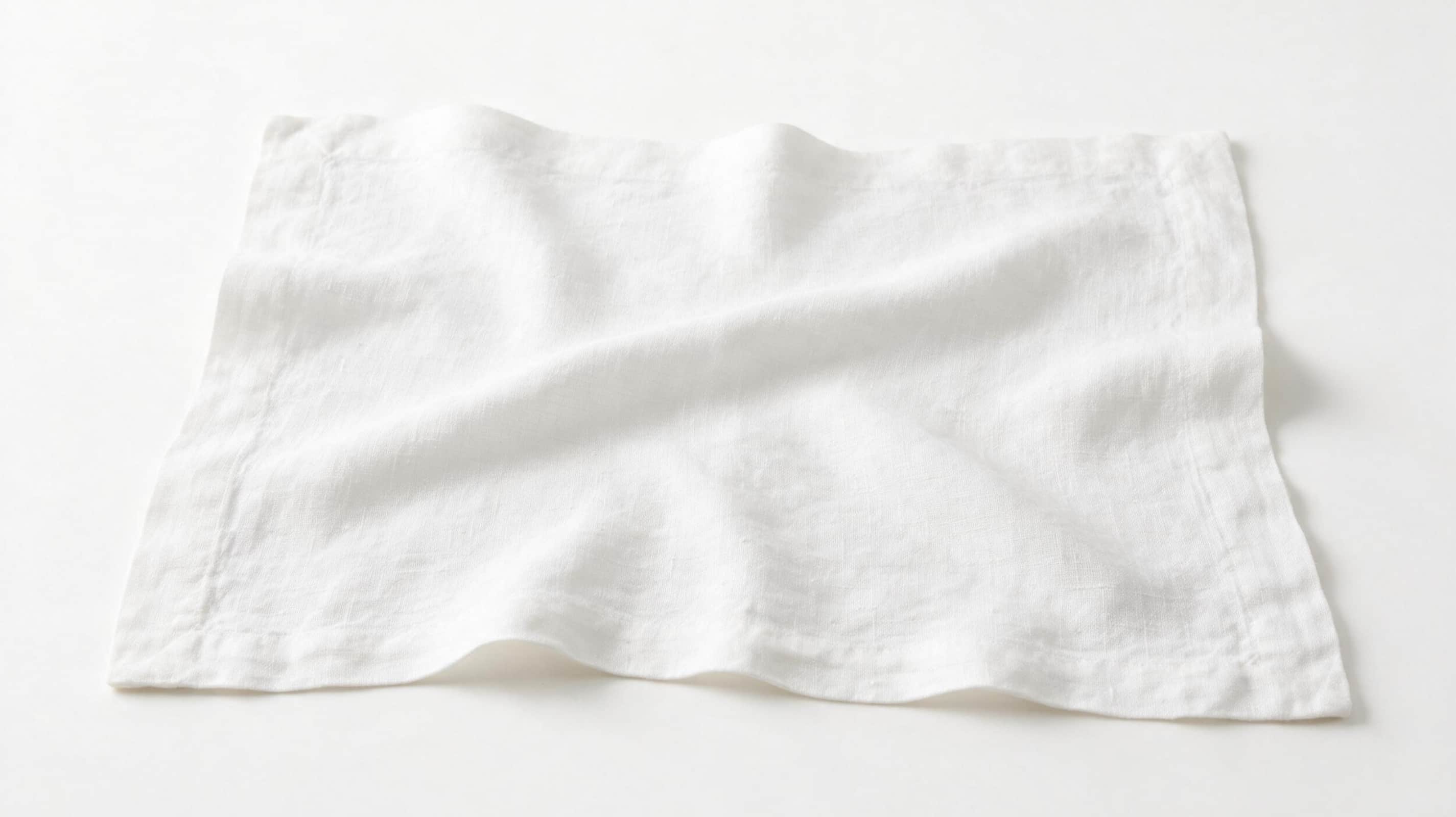 Four premium white European linen placemats displayed on a pure white background with authentic woven linen texture.