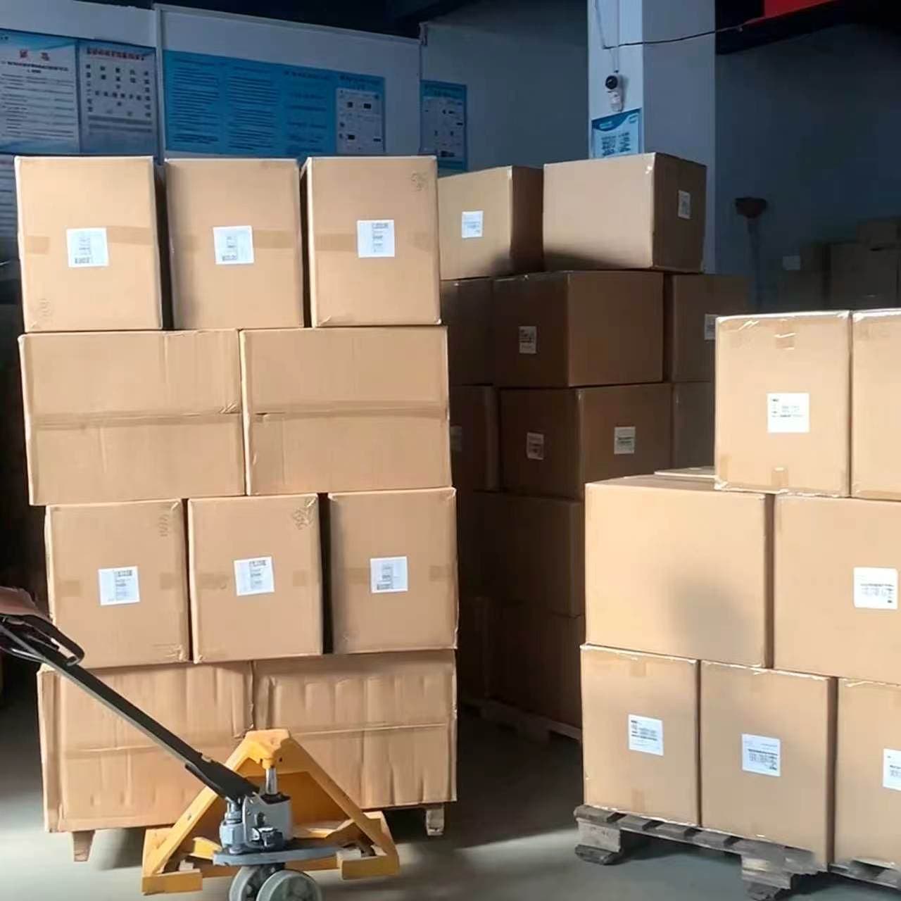 Labeled linen bulk order boxes stacked on warehouse pallet