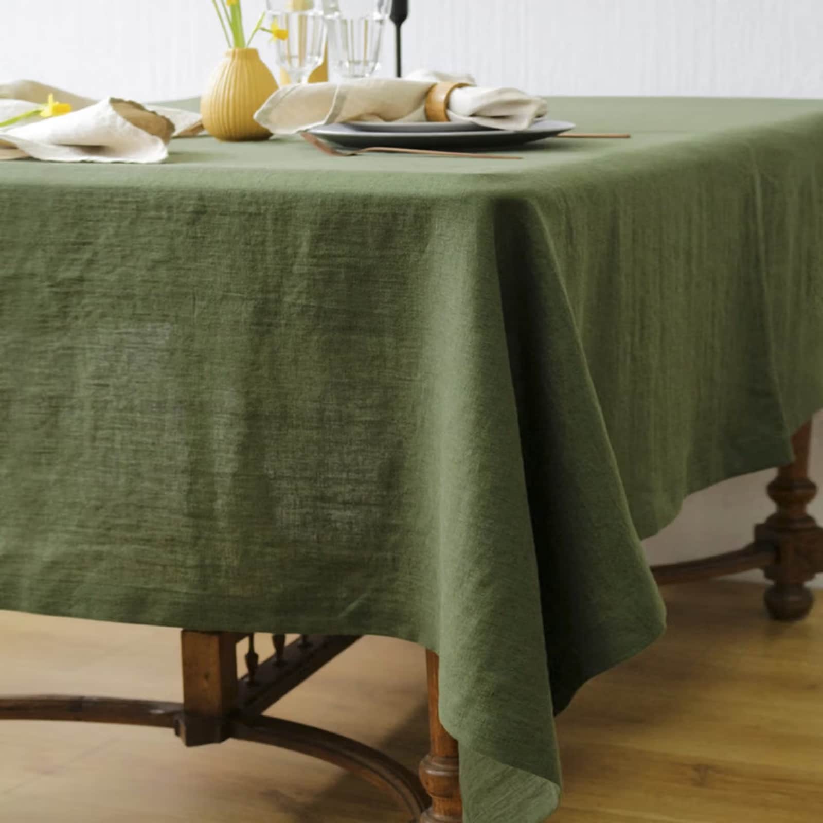 Forest green linen tablecloth with full restaurant table setting