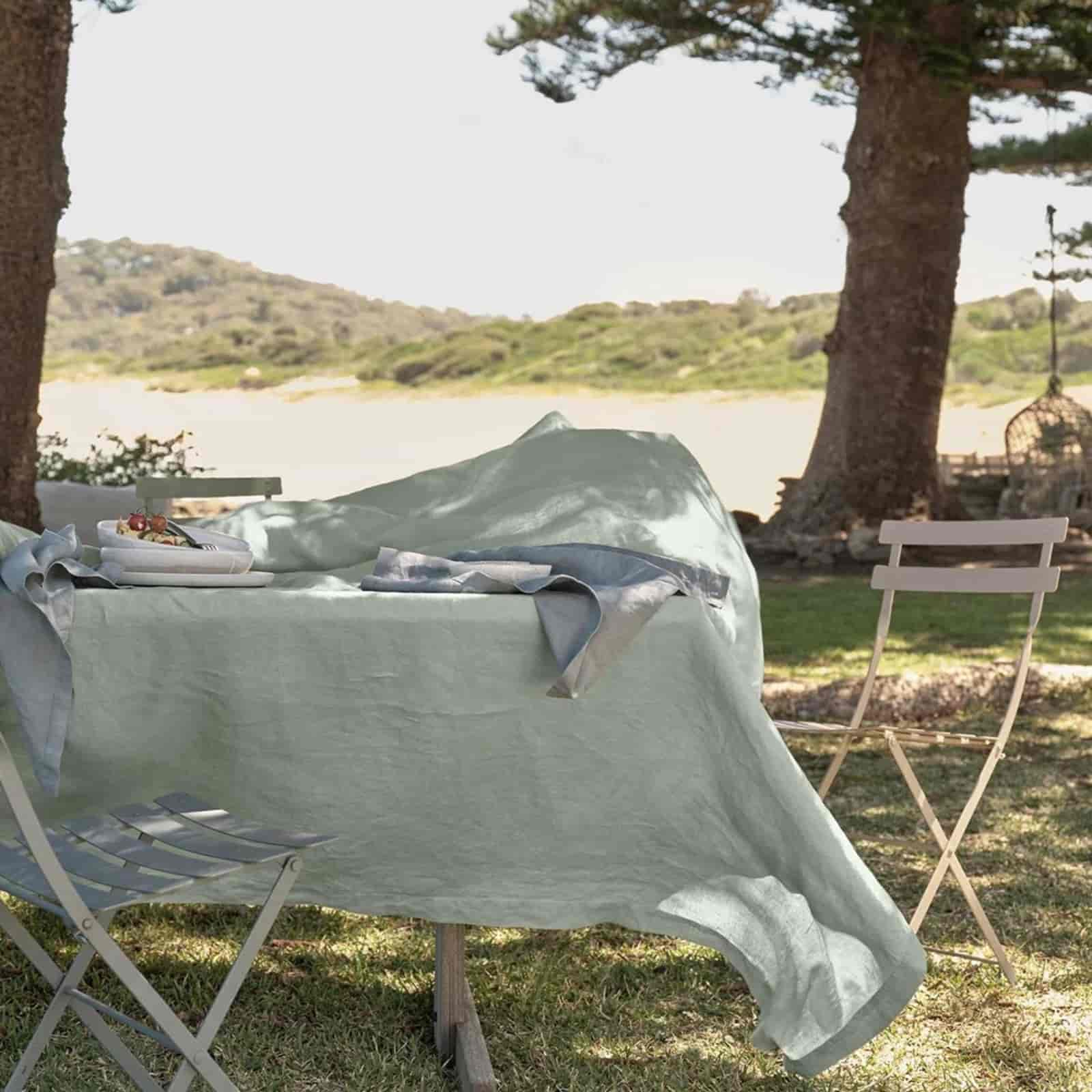 Sage green linen tablecloth for outdoor lakeside dining