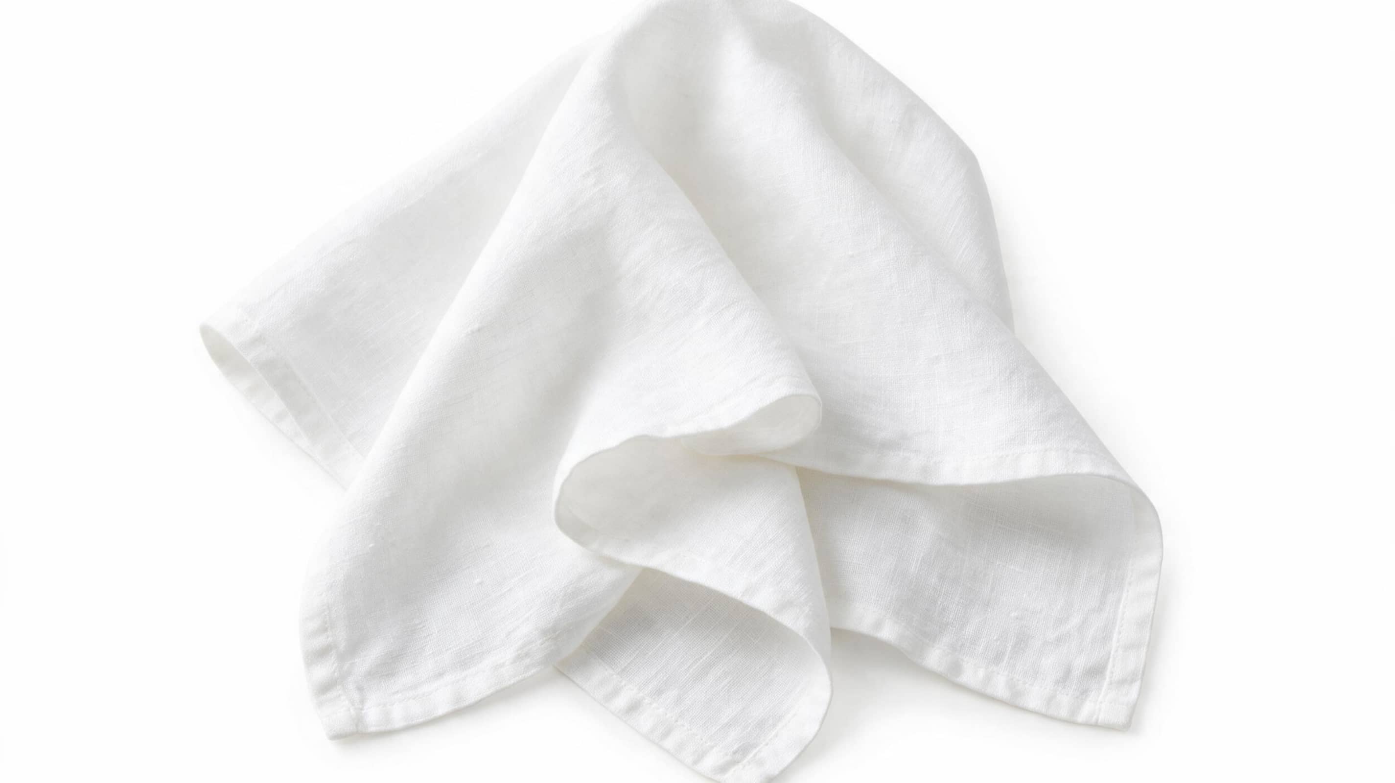 Four premium European linen napkins folded on a white background with authentic natural linen texture.