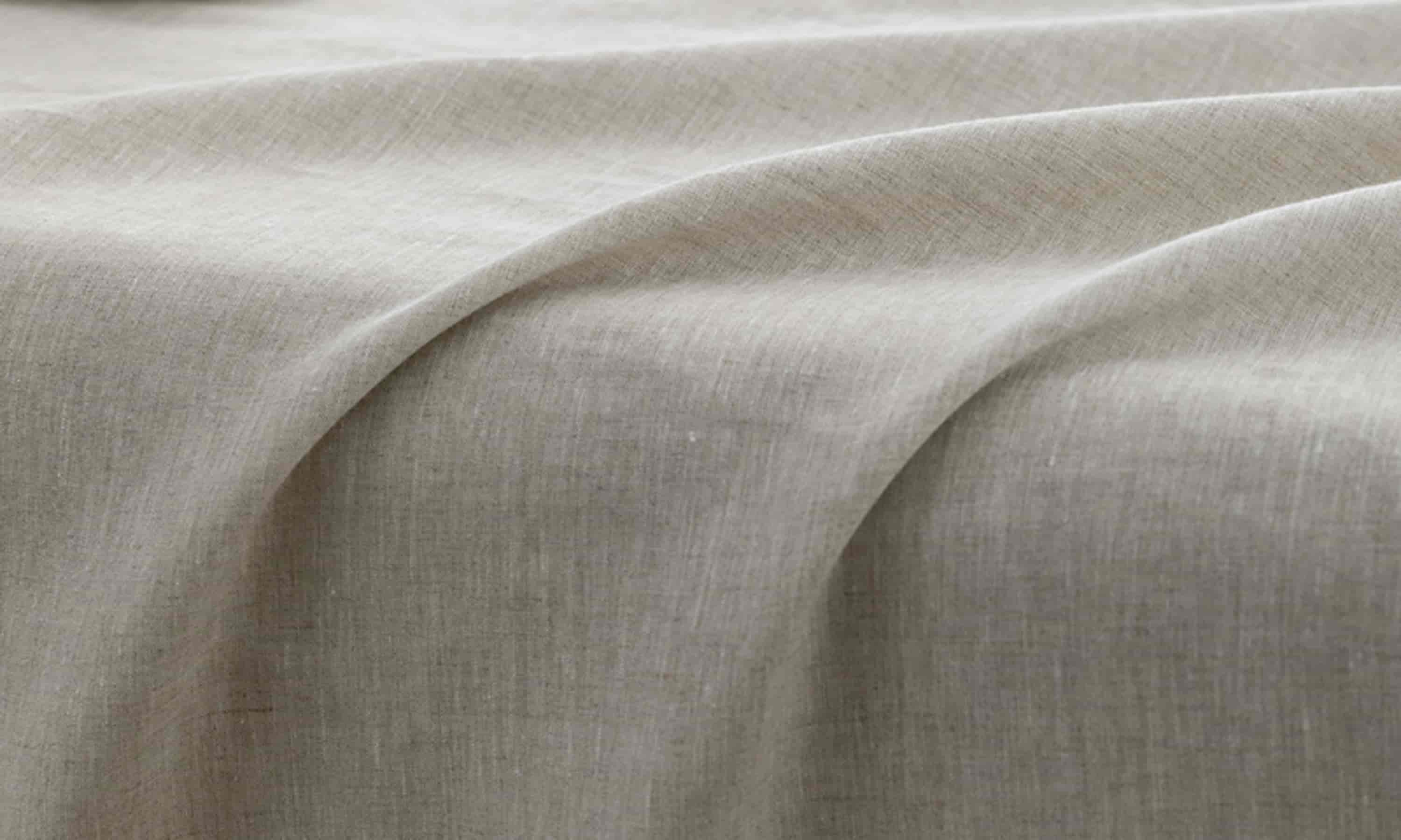 Natural linen tablecloth texture with coffee cup detail