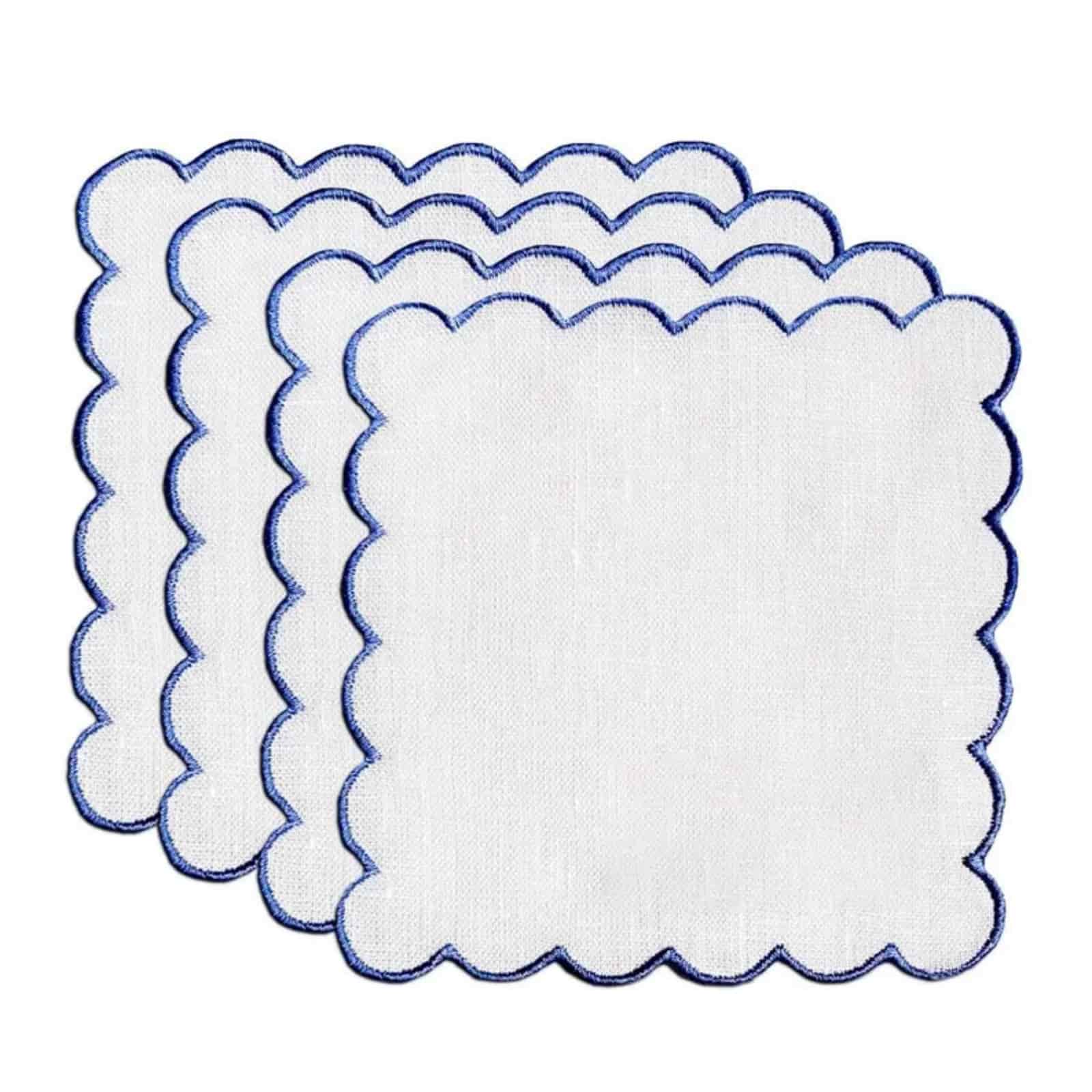 Elegant scalloped edge cocktail napkins crafted from 100% French flax, showing precision lockstitch contouring.