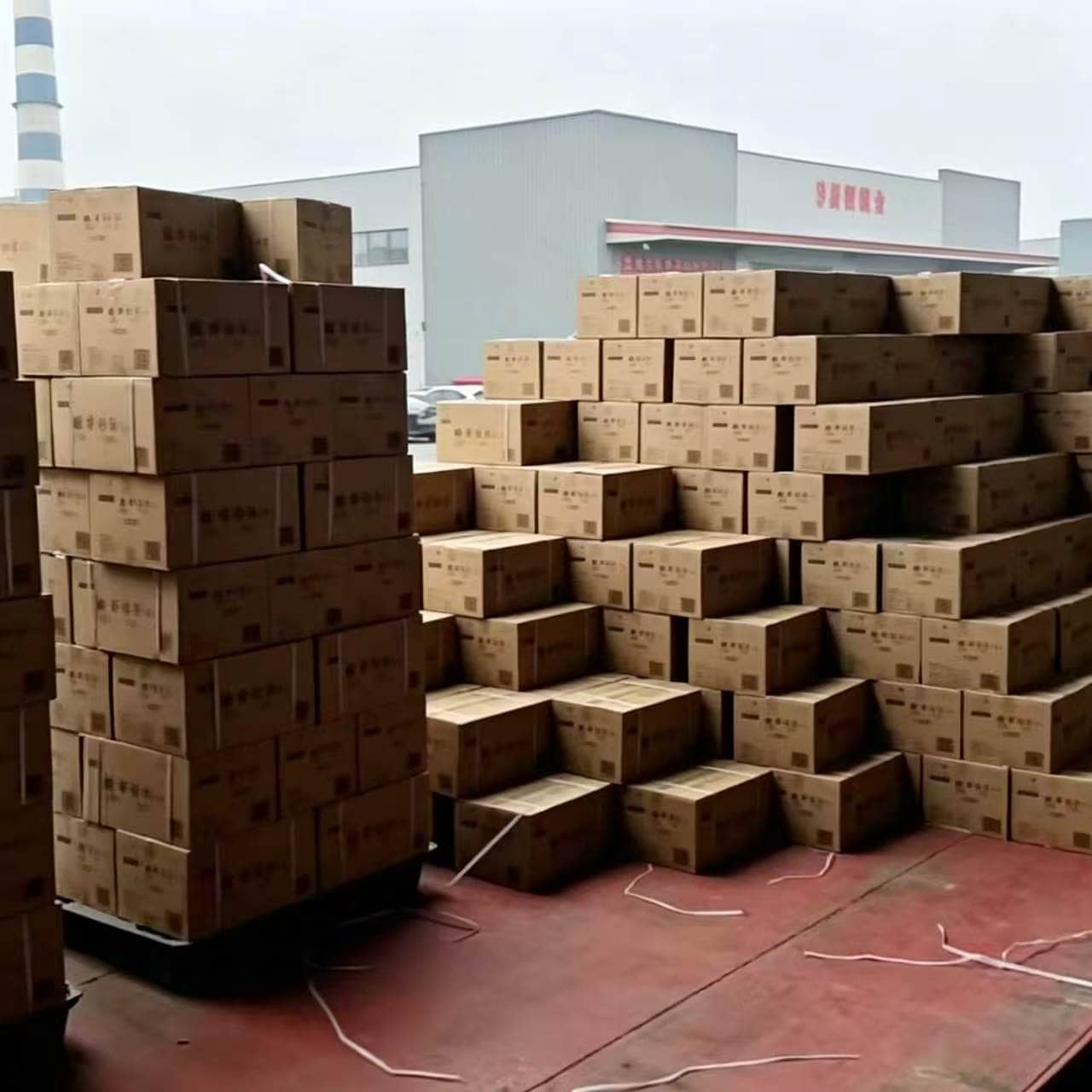 Linen bulk order boxes stacked outdoors beside truck