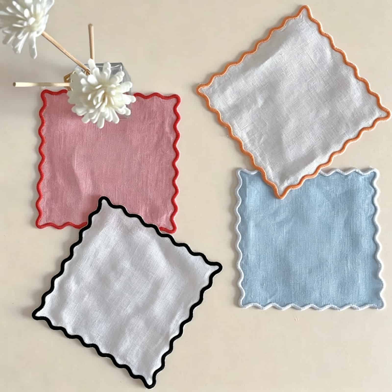 A stack of solid color custom cloth cocktail napkins in bulk, dyed to match premium contract brand identity.