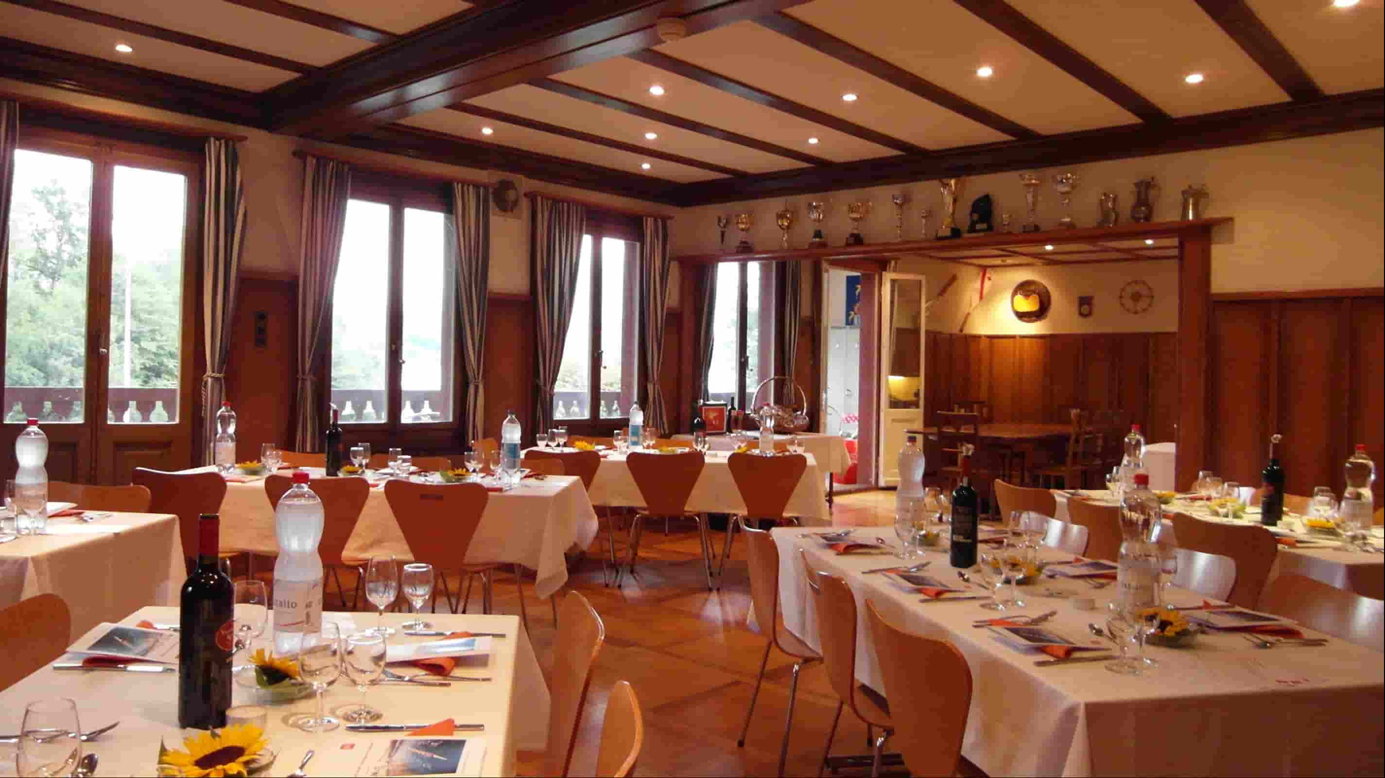 Crisp white linen tablecloths on multiple round and rectangular tables in a bright hotel banquet hall with sunflower centerpieces